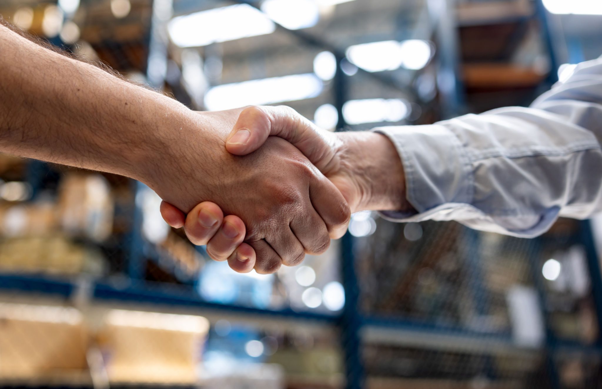Handshake in warehouse setting